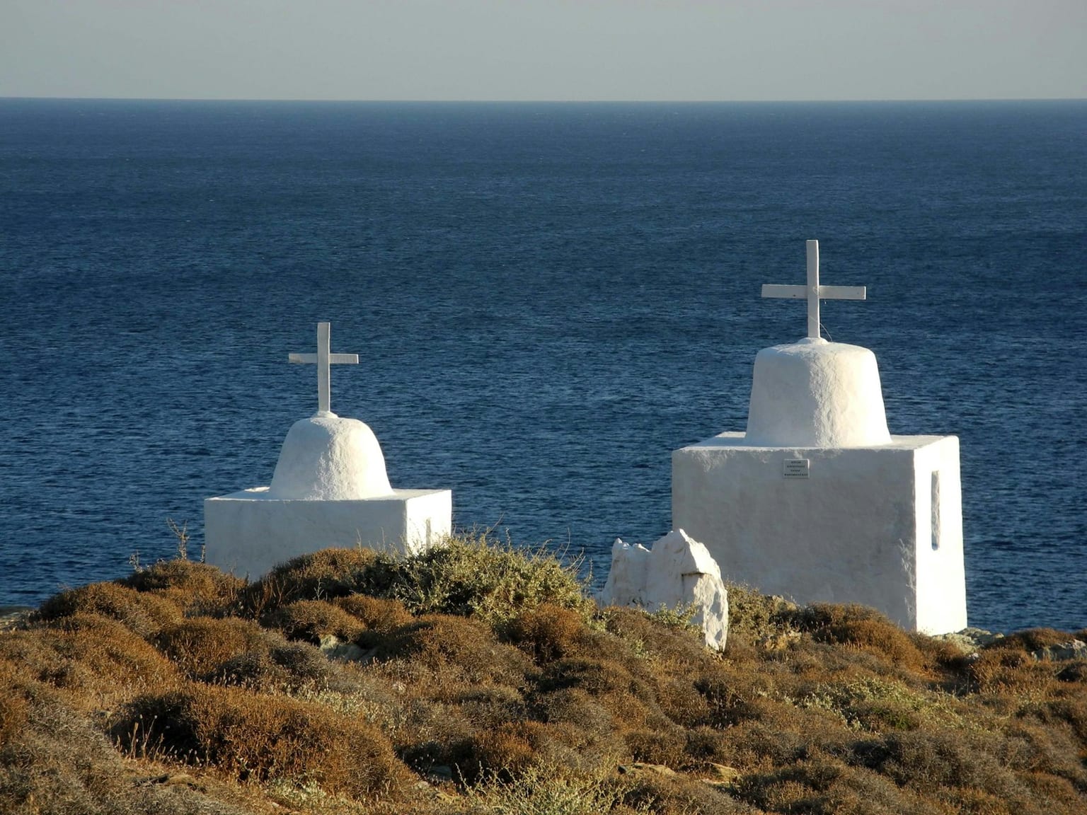 An empty cliff-top village lane on a quiet Greek island