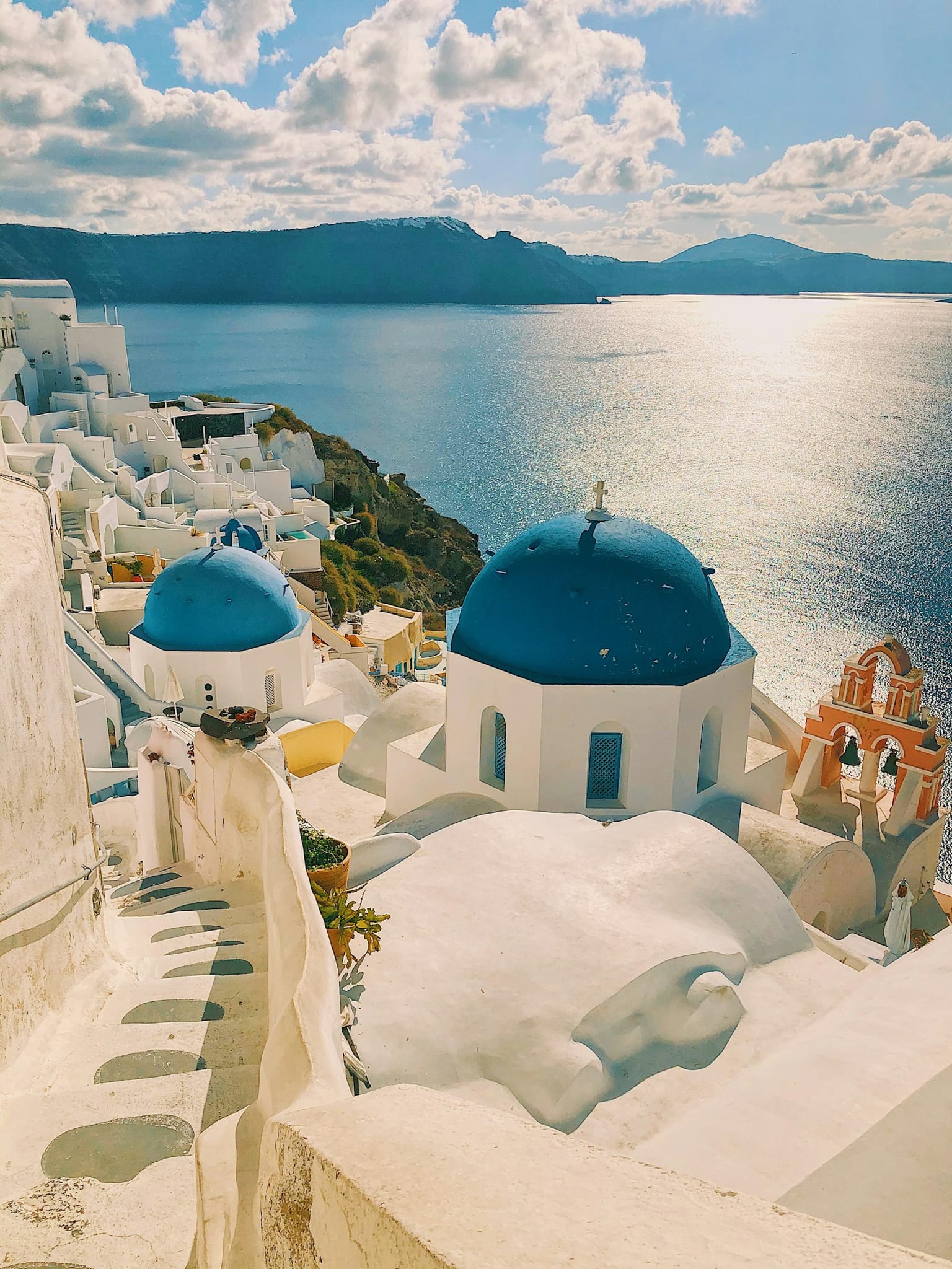 Whitewashed cliffside town overlooking the sea at sunset